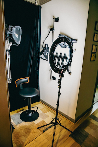 A selfie station with a chair, ring light and tools.